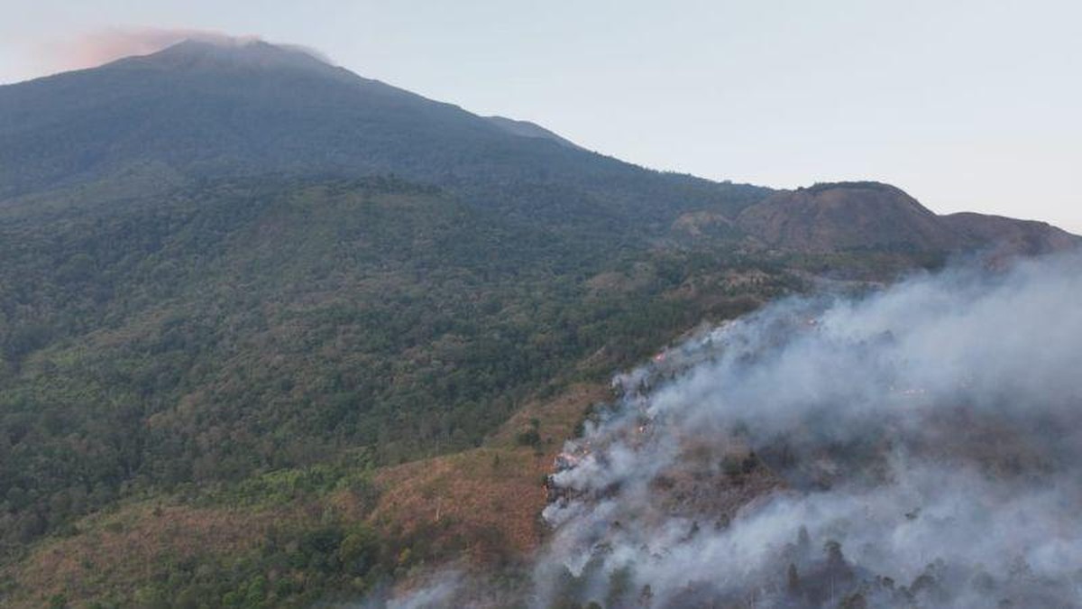 Smoke rising from burned forest on the slope of Mount Ciremai